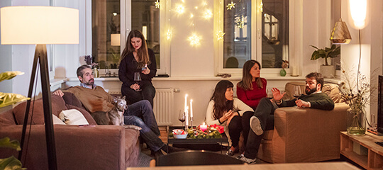 Family together in a living room.