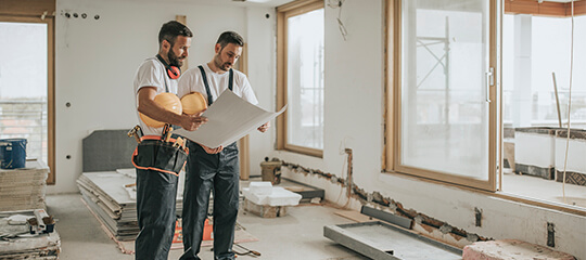 Workers reading construction plans.