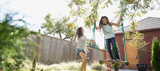 Kids playing in a backyard.