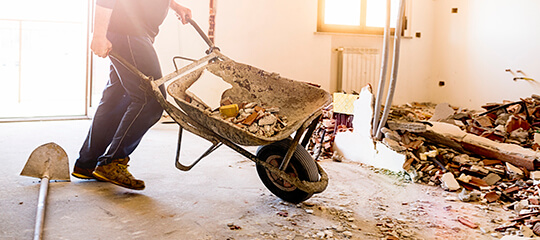 A wheelbarrow being pushed through a room in a home.