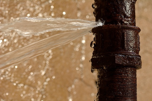 burst rusty water pipe floods home