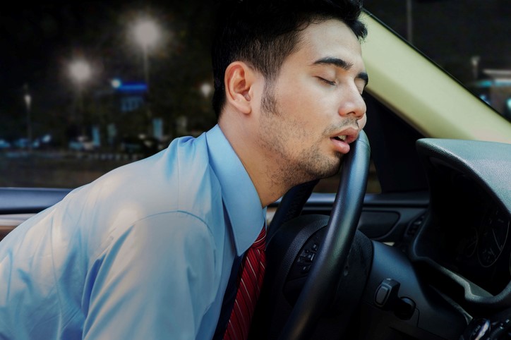 man-asleep-behind-wheel