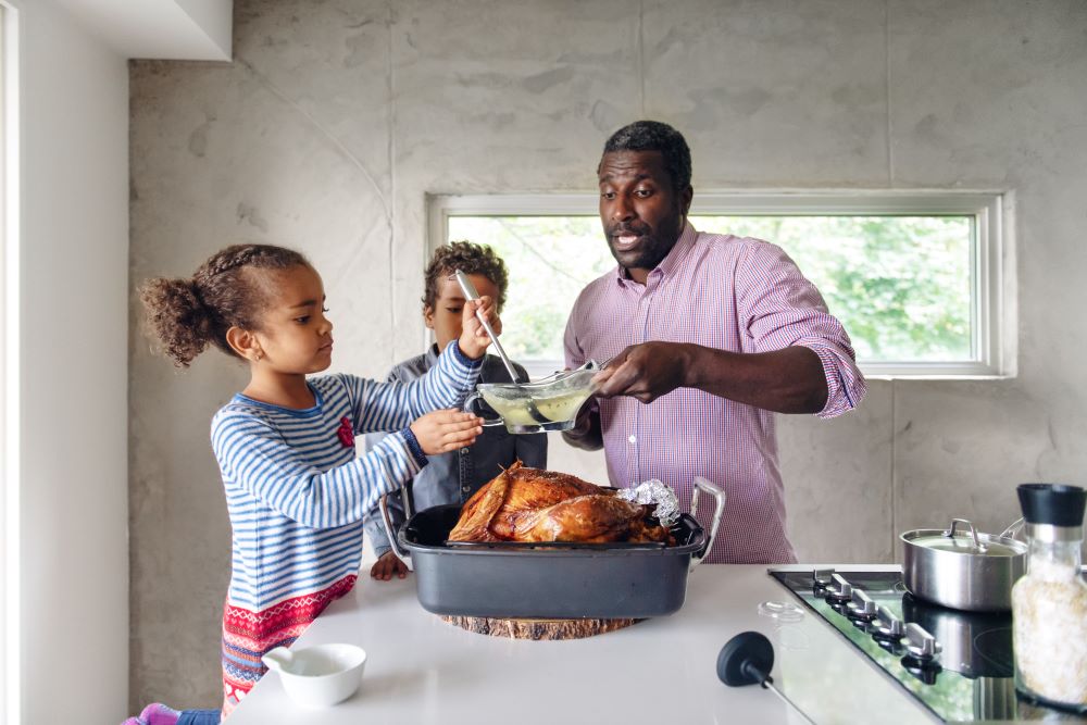 Family cooking turkey.