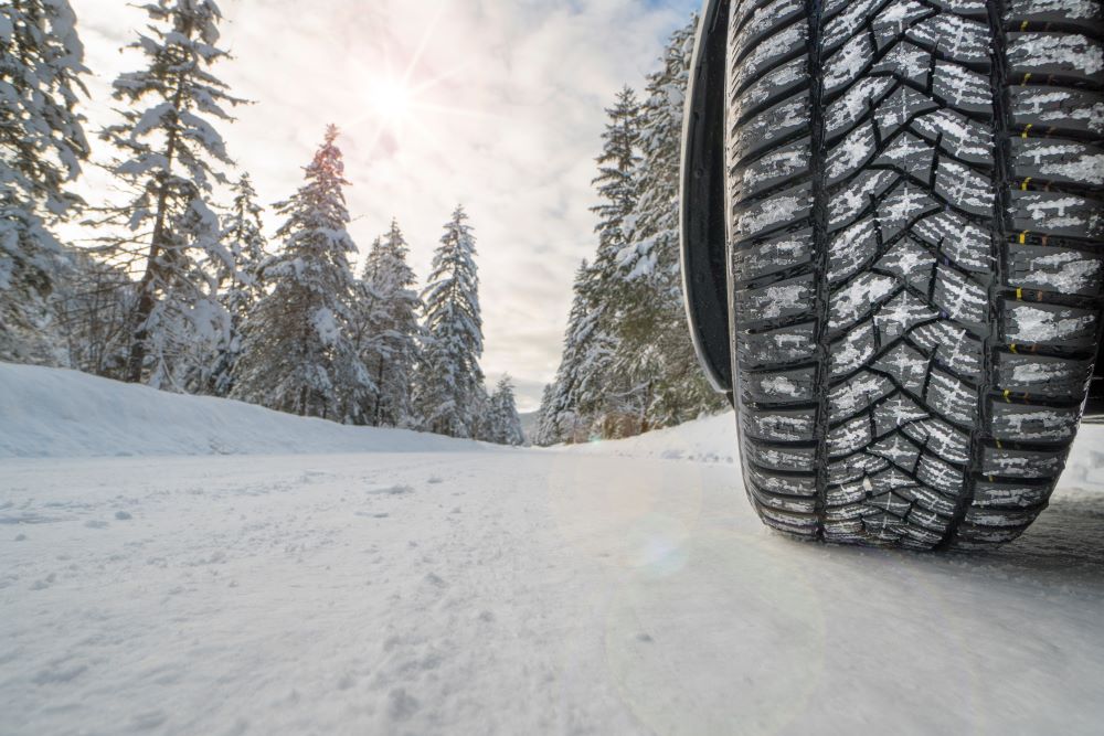 Car tire on snowy road.