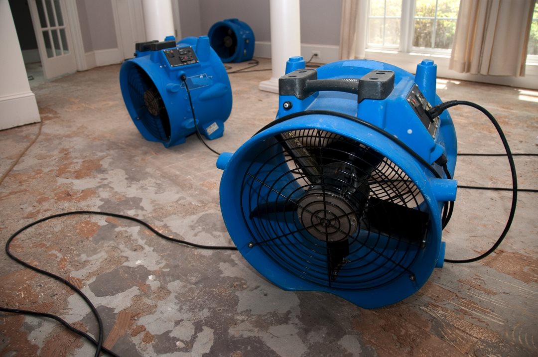 Air blowers drying out a wet home.